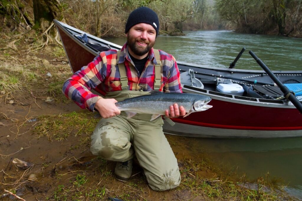 Fisherman holding steelhead trout